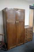 An 1930's oak gent's wardrobe and matching five drawer chest.