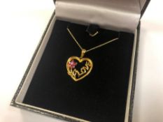 A 10ct gold diamond and ruby heart pendant on chain CONDITION REPORT: 2.2g.