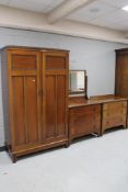 A three piece Edwardian mahogany bedroom suite comprising of gent's wardrobe,