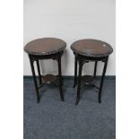 A pair of circular plant tables.