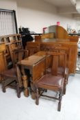 A 1930's six piece oak dining room suite : mirror backed sideboard, drop leaf table and four chairs.
