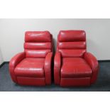 A pair of red leather Laz-y-Boy armchairs.