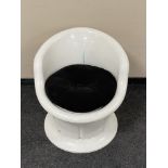 An Ikea white plastic tub chair.