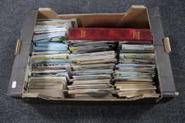 A large box of antique and later postcards;