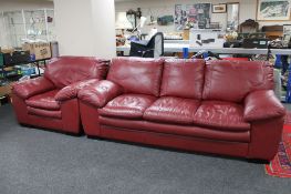 A red leather three seater settee and armchair.