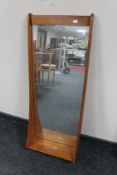 A mid 20th century teak hall mirror with shelf CONDITION REPORT: Glass with surface