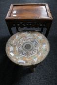 A tribal three legged stool and a Chinese carved hardwood table.