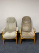 A pair of beech framed high backed armchairs.