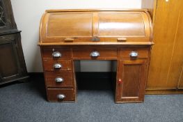 An early 20th century twin pedestal roll top desk.