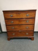 A George III mahogany four drawer chest on bracket feet,