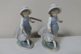 Two Nao figures of girls with hoops