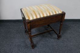 An Edwardian piano stool with music drawer.