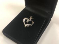 A 10ct white gold diamond set heart pendant CONDITION REPORT: 2.2g.