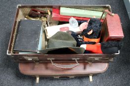 Two vintage luggage cases of assorted brass ware, mid 20th century mechanical monkey,