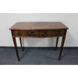 A 20th century mahogany bow-fronted console table.