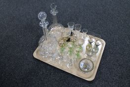 A tray containing two early 20th century liqueur decanters together with a collection of assorted