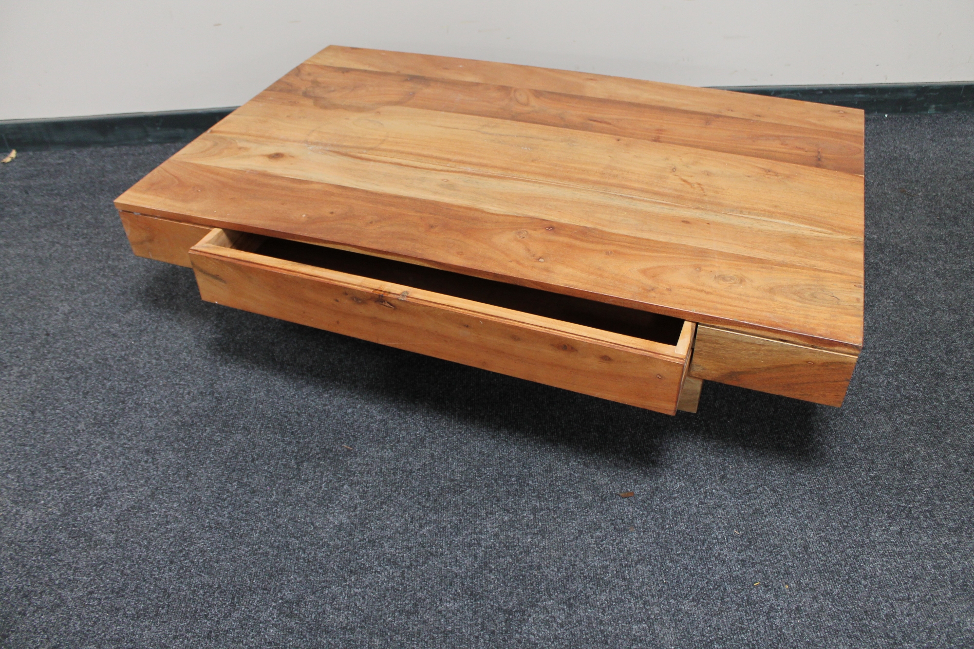 A sheesham wood coffee table fitted a drawer.