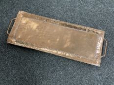 An Arts and Crafts copper tray by John Pearson, 54 cm x 19 cm.