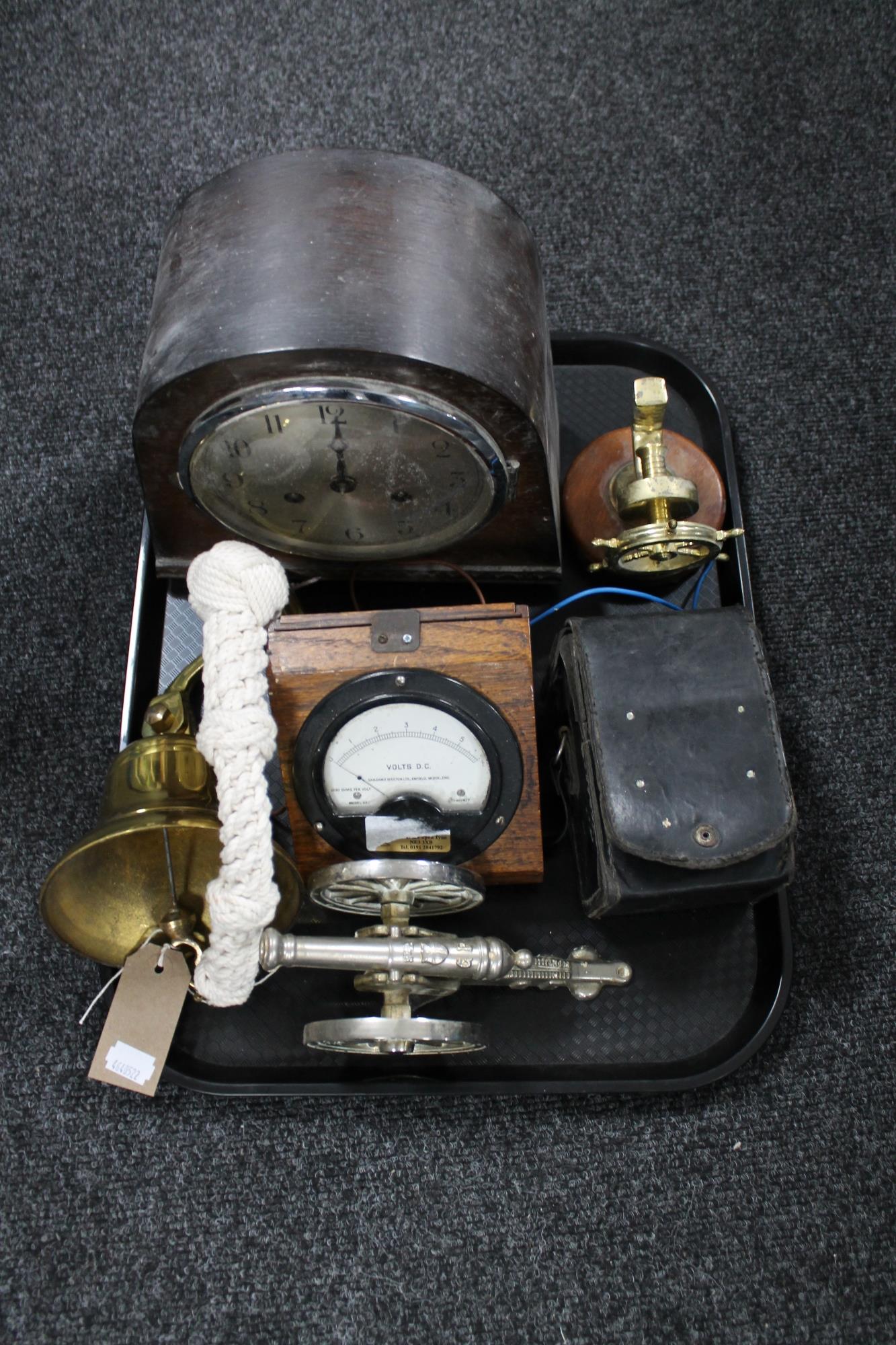 A tray of oak cased Art Deco mantel clock, brass ship's bell, miniature metal cannon,