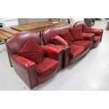 A 1930's red vinyl upholstered three piece suite