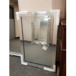 An all glass framed mirror,