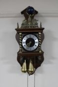 A continental wall clock with brass pear drop weights