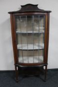 A late Victorian inlaid mahogany bow-fronted display cabinet.