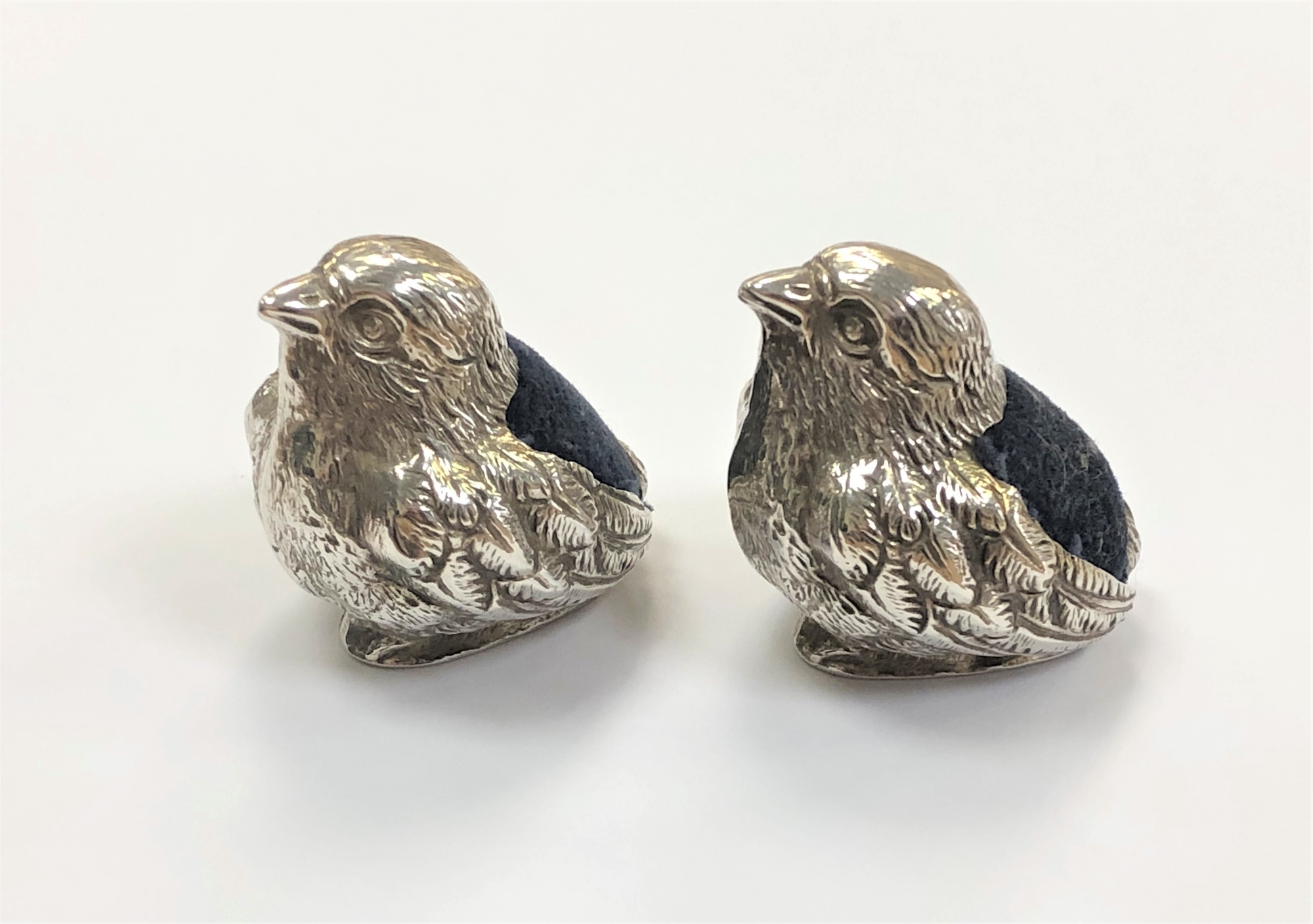 A pair of Edwardian silver pin cushions, realistically modelled as chicks, Sampson Mordan & Co,