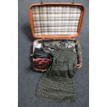 A vintage luggage case containing Orla Kiely purse, leather hand bag, unworn leather cowboy boots,