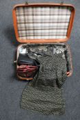 A vintage luggage case containing Orla Kiely purse, leather hand bag, unworn leather cowboy boots,