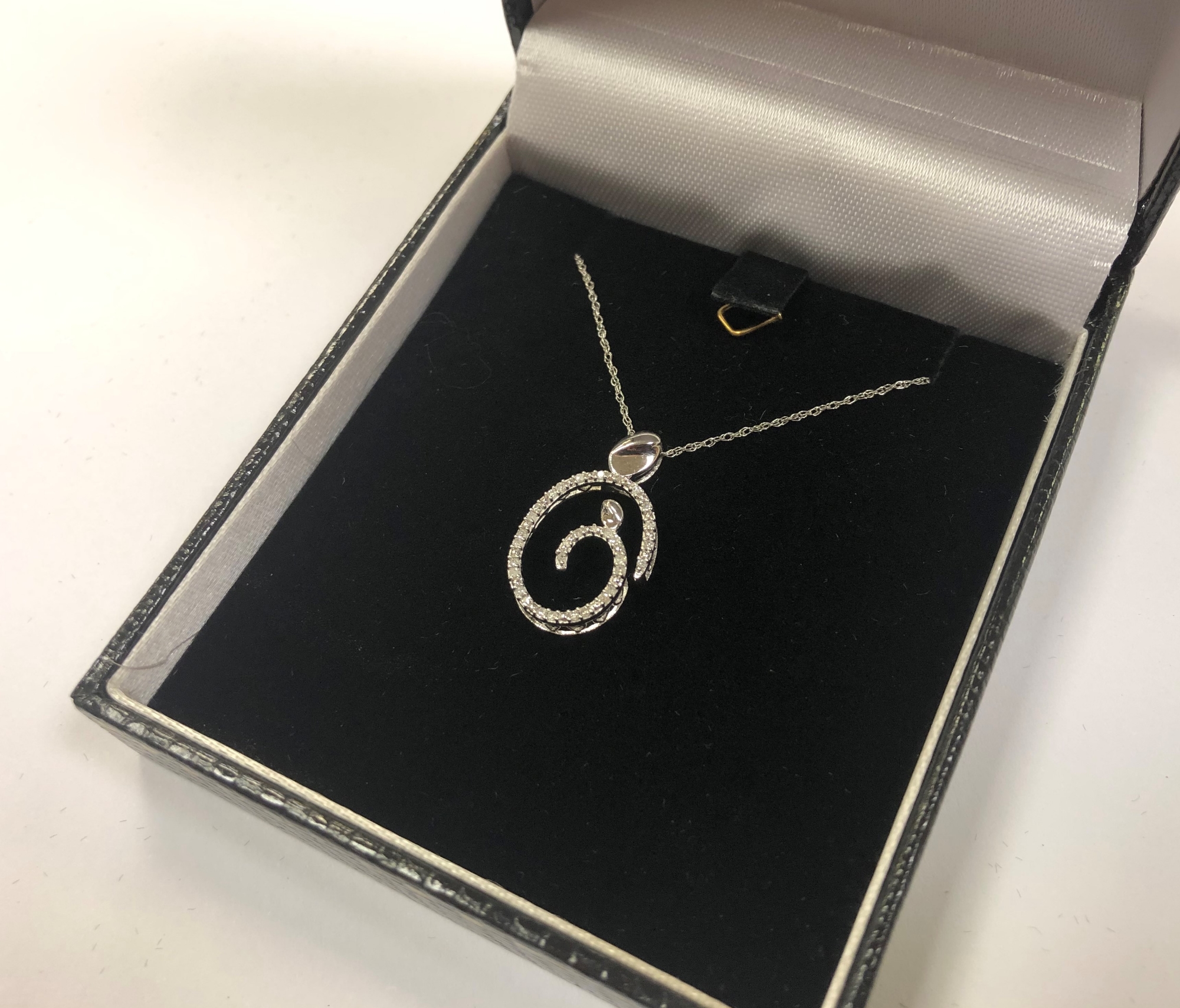 A 10ct white gold diamond set pendant on chain CONDITION REPORT: 1.6g.