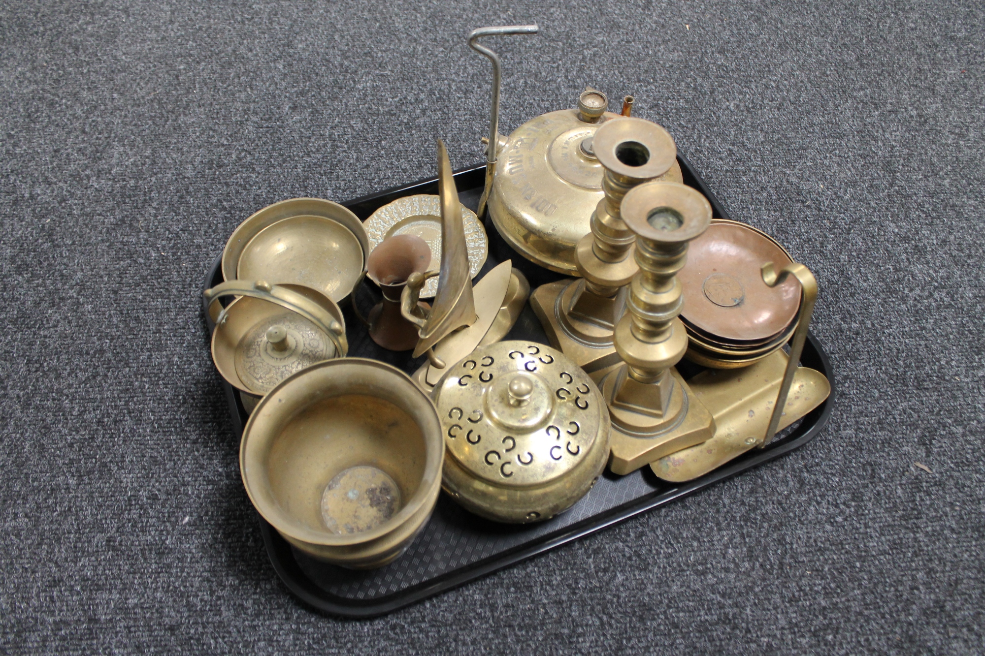 A tray of antique and later brass ware, Primus stove, lidded pot, brass wind surfer figure,