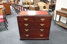 A reproduction mahogany five drawer chest with red leather inset panel.