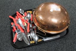 A tray of copper lidded cooking dish together with stainless steel and plated cutlery