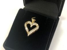 A 10ct yellow gold diamond set heart pendant CONDITION REPORT: 2.9g.