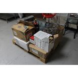 A pallet of metal plate stands, drinking glasses, wooden easel, fire extinguishers, etc.