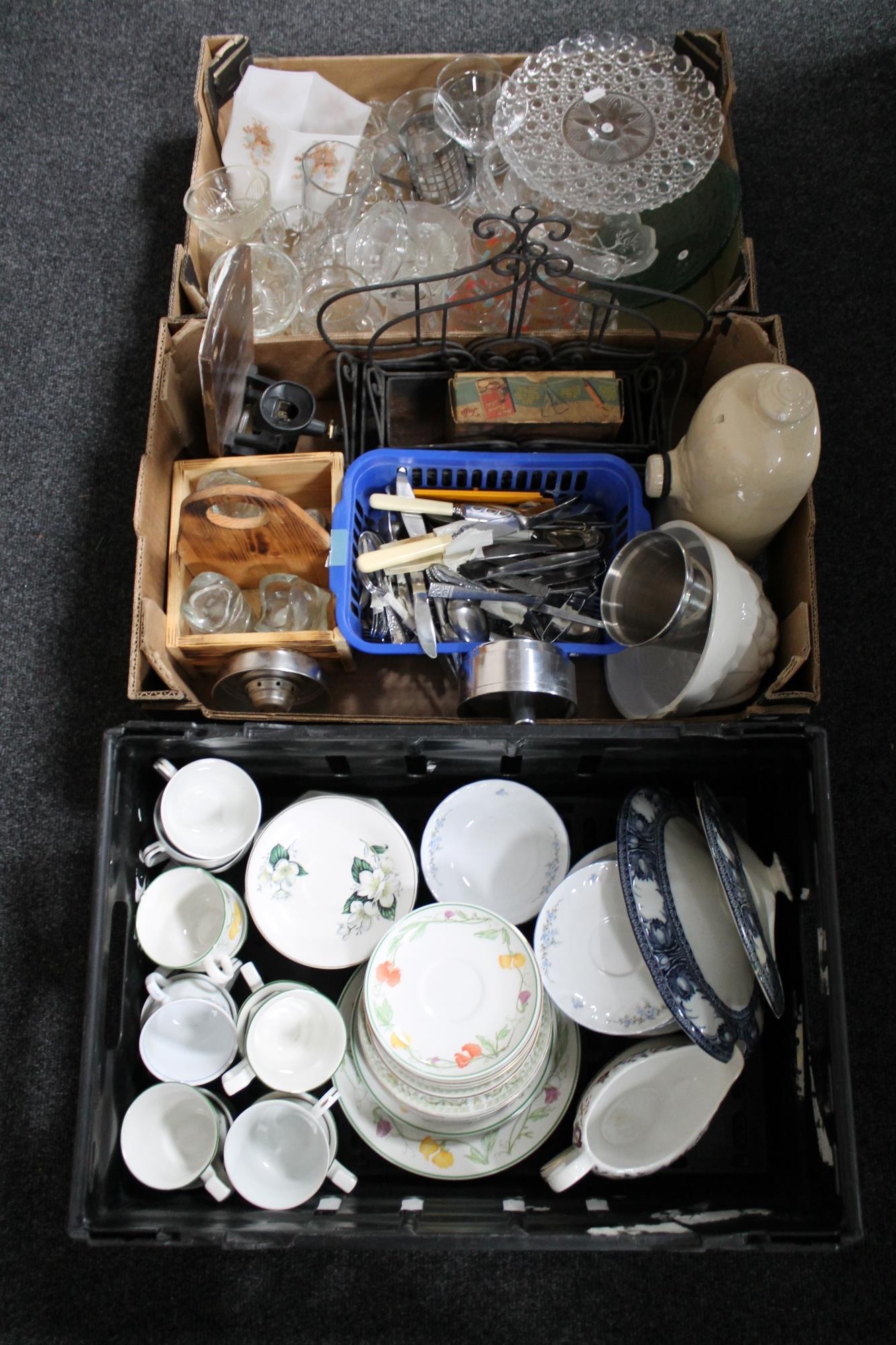 Two boxes and a crate of assorted tea china, glass ware, stoneware hot water bottle, cutlery,