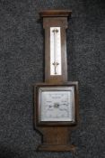 An oak barometer/thermometer with square silvered dial