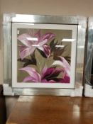 A framed print of a flower,