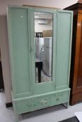 A mid century painted oak wardrobe fitted with a drawer
