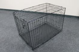 A folding metal dog cage