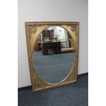 A Victorian style gilt framed overmantel mirror with oval glass.