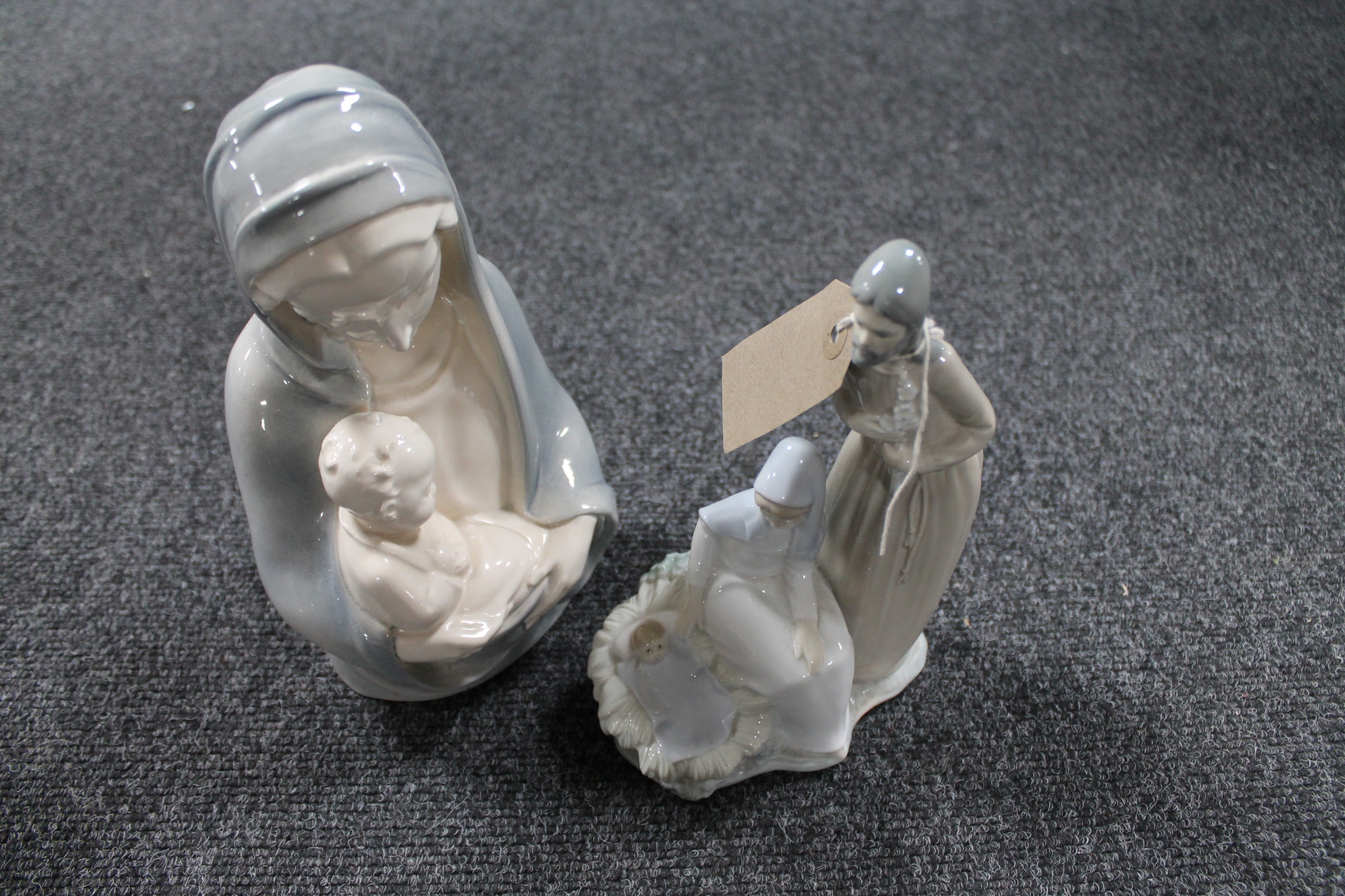 A Nao figure of Mary and Joseph with Jesus together with a continental religious figure