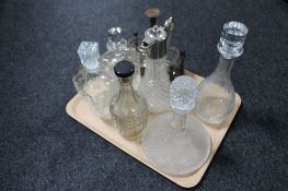 A tray containing six assorted cut glass decanters and claret jug together with a wooden bottle