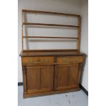 An Edwardian pine double door sideboard and a later pine plate rack