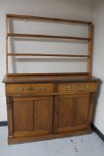 An Edwardian pine double door sideboard and a later pine plate rack