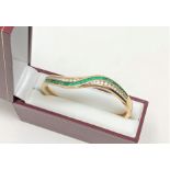 A fine quality 18ct gold emerald and diamond bangle CONDITION REPORT: 26g.