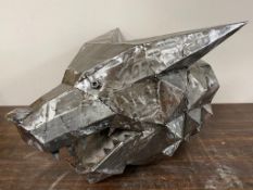 A reclaimed metal sculpture of a wolf head