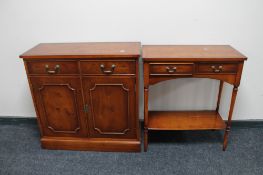 An inlaid yew wood double door cabinet fitted with two drawers together with two tier hall table