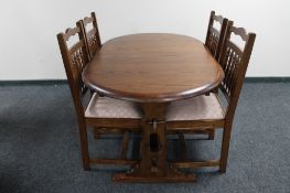 A contemporary oak oval extending table and four chairs